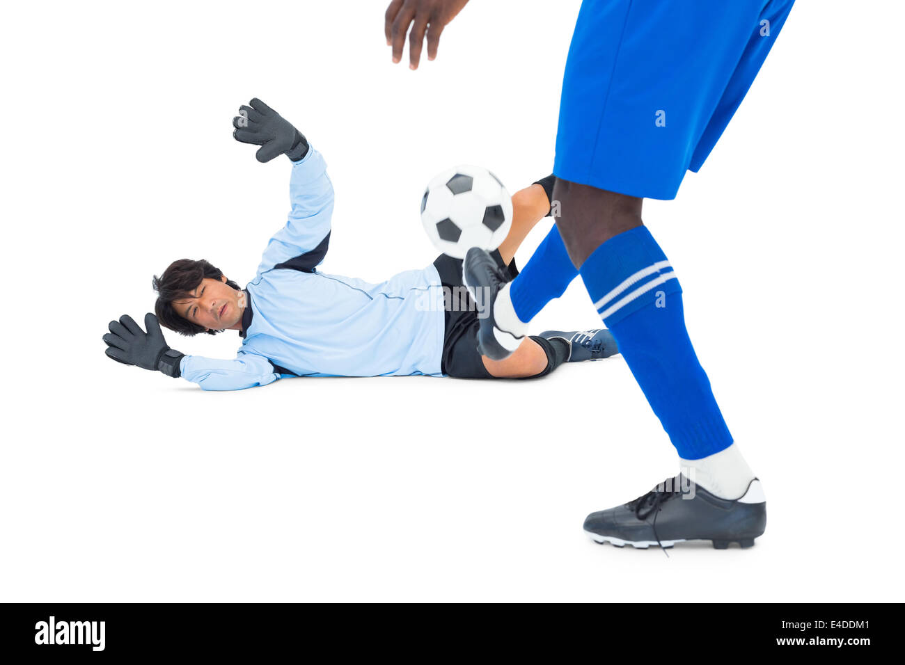 Striker hitting football at goalkeeper Stock Photo Alamy