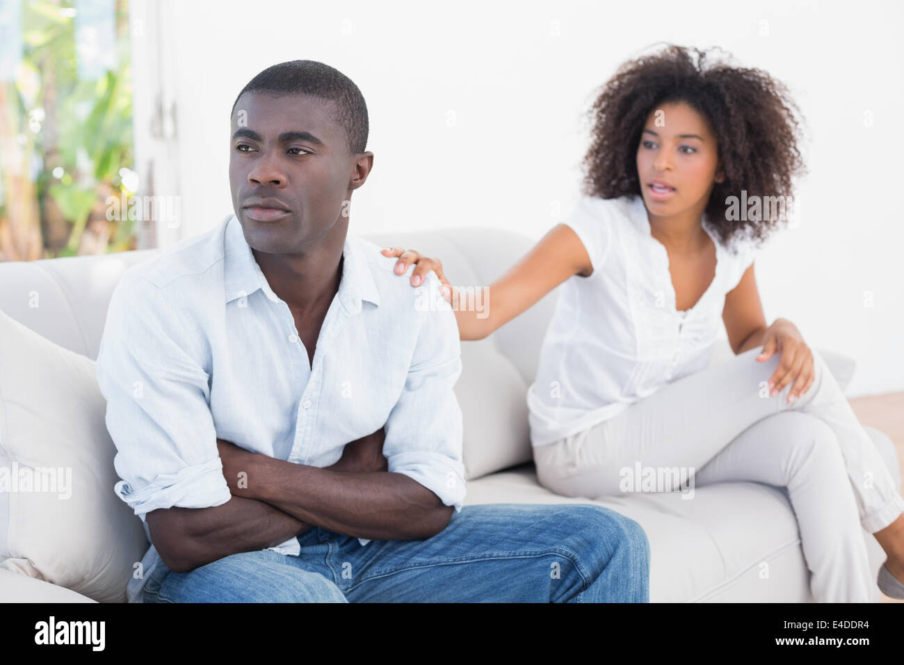 Attractive couple having an argument on couch Stock Photo - Alamy