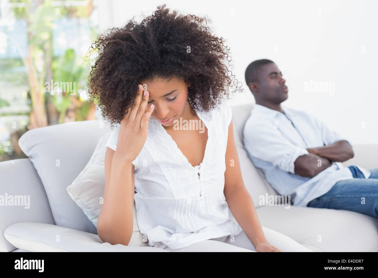 Attractive couple having an argument on couch Stock Photo - Alamy