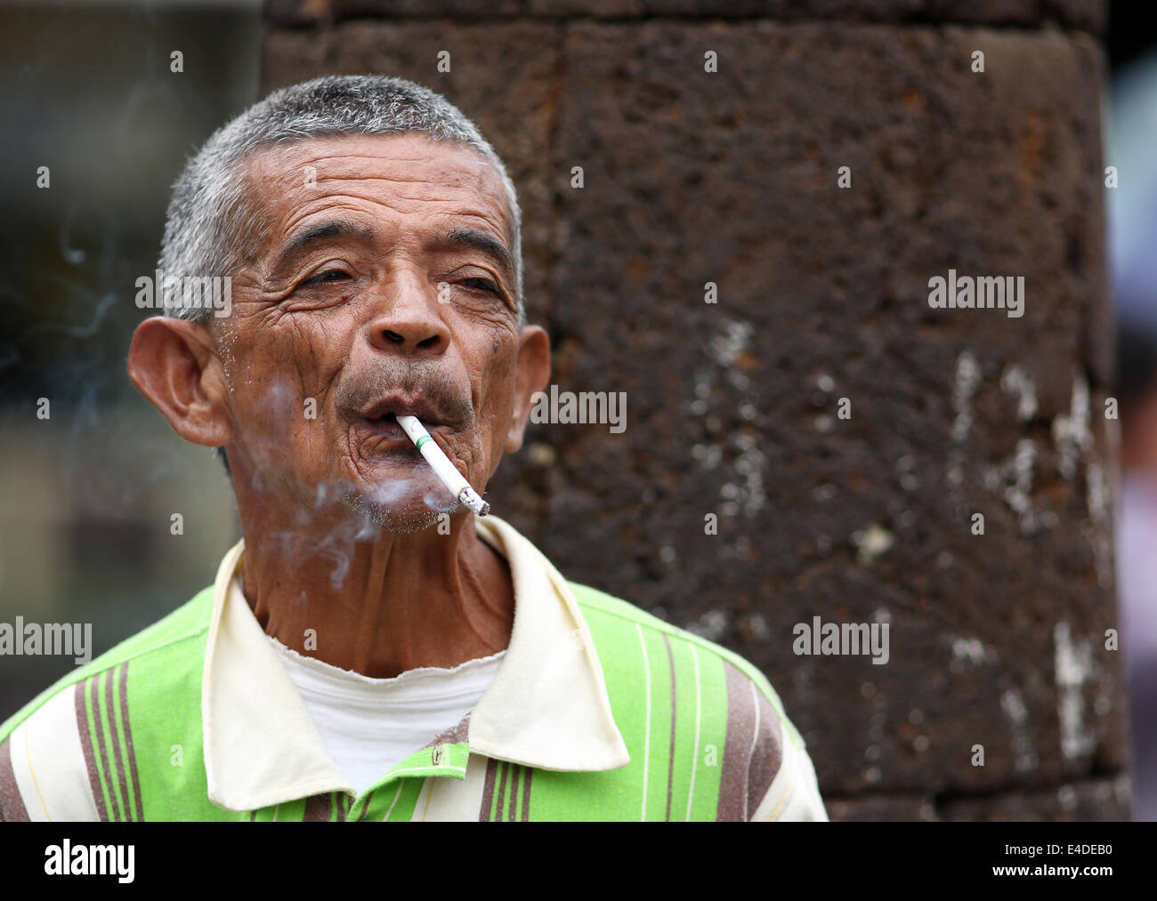 Man smoking in the street in central Medellin, Medellín, Colombia Stock