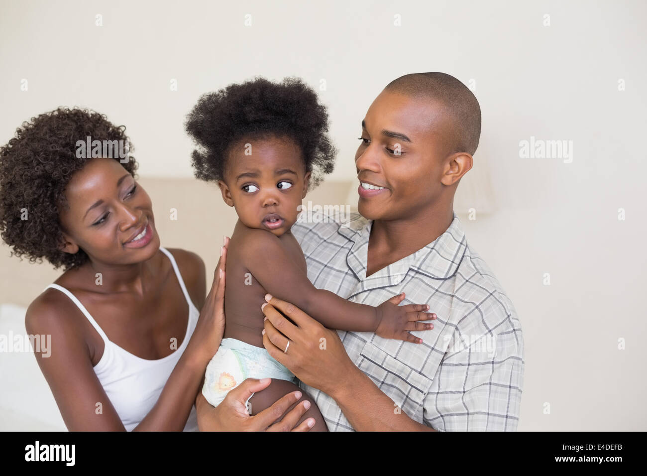 Happy parents with their baby girl Stock Photo