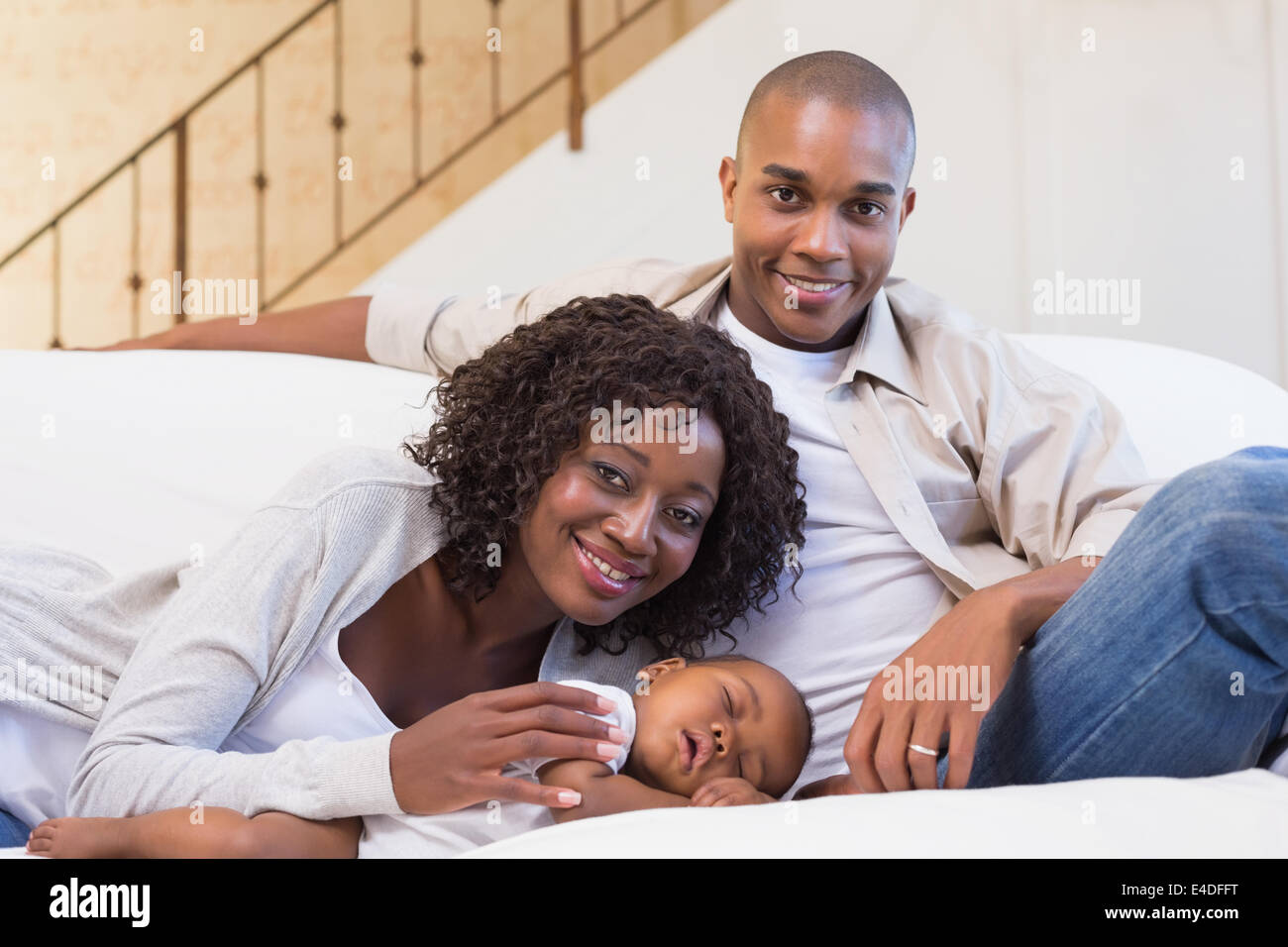 Adorable baby boy sleeping while being watched by parents Stock Photo