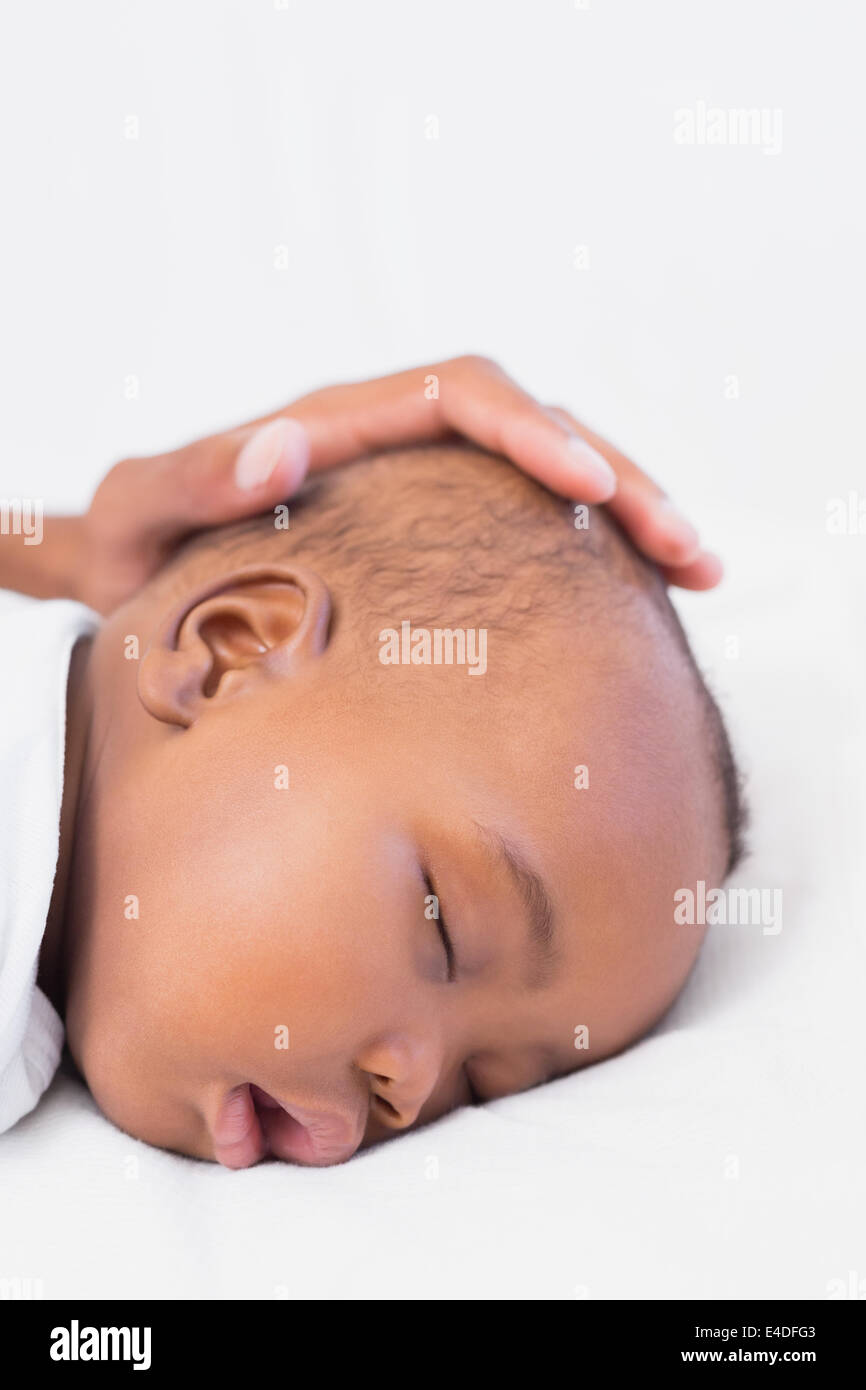 Adorable baby boy sleeping with fathers hand on head Stock Photo