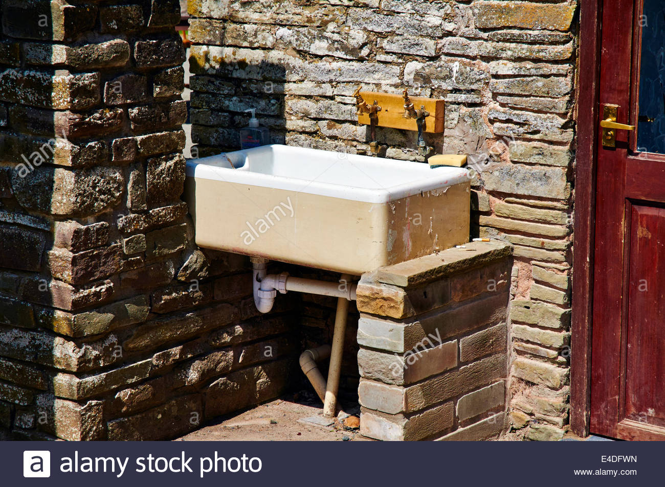 A Belfast Sink Outside A Stone Building On A Camping Site