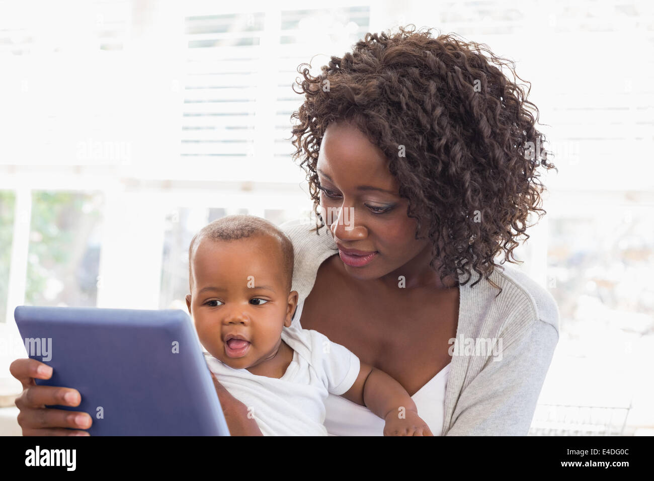 Happy mother using tablet pc with baby boy Stock Photo