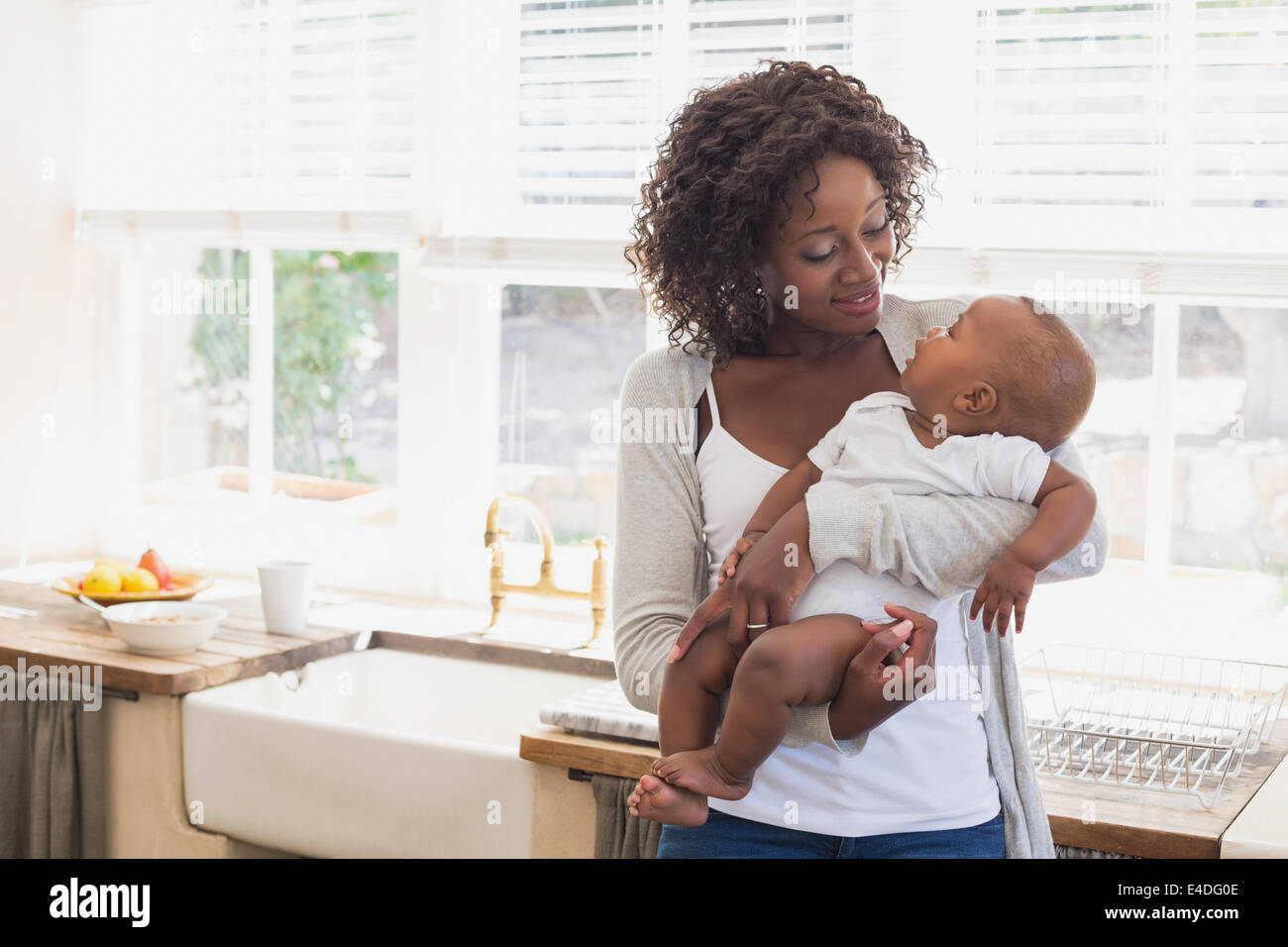 Happy mother holding her baby boy Stock Photo