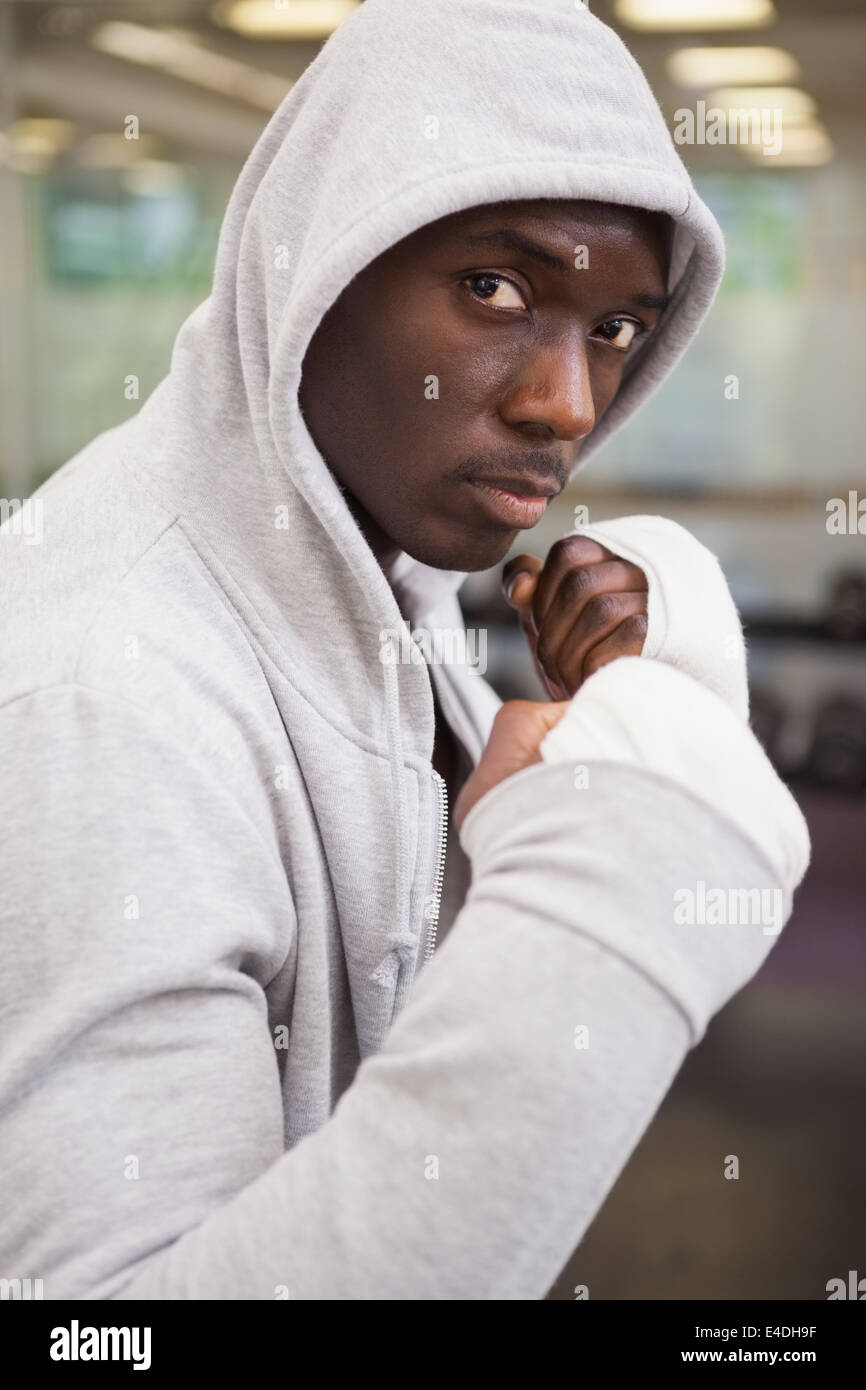 Boxer in hood jacket at health club Stock Photo
