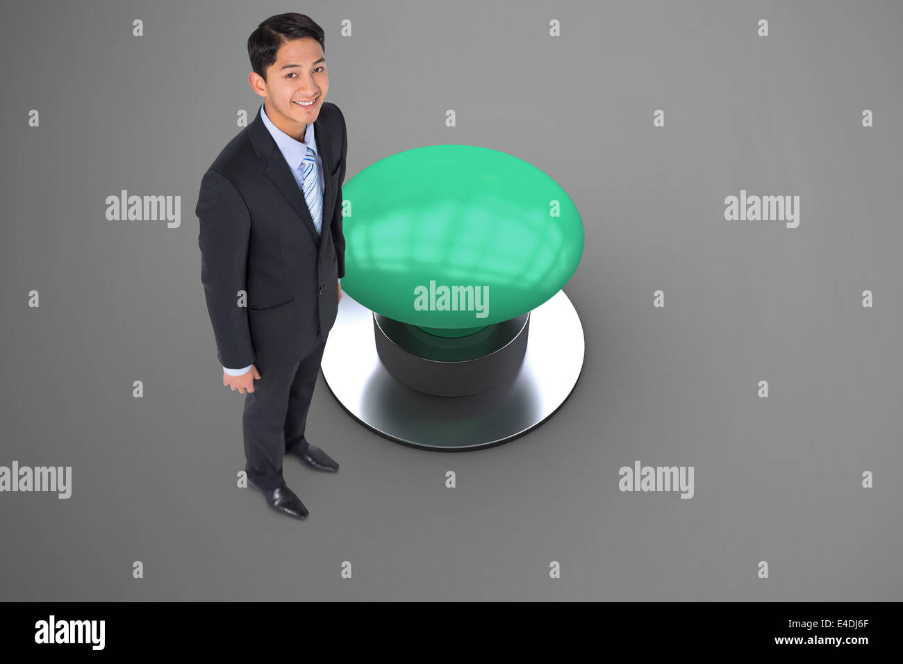 Composite image of smiling asian businessman pointing Stock Photo - Alamy