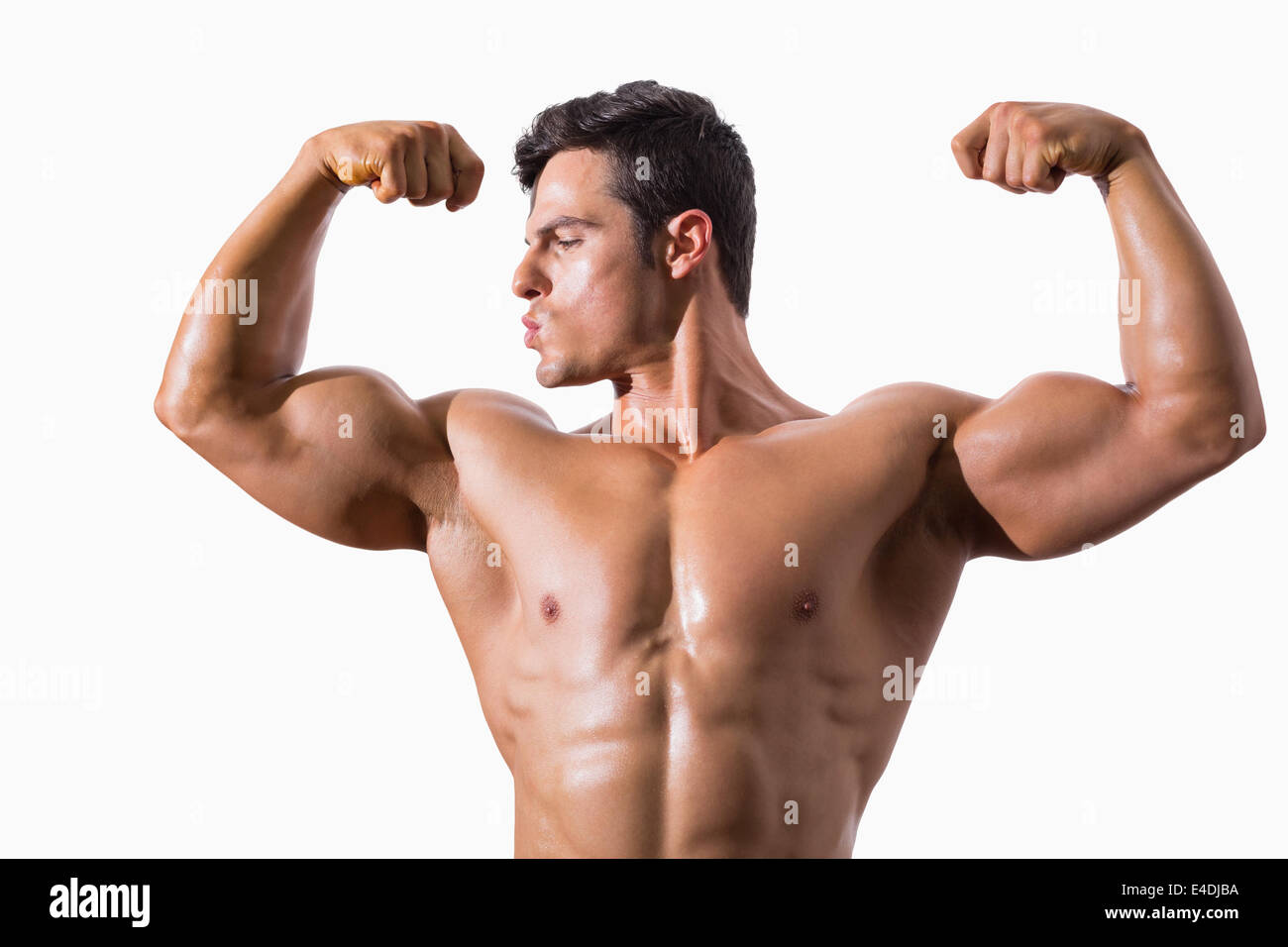 Portrait of a muscular young man flexing muscles Stock Photo