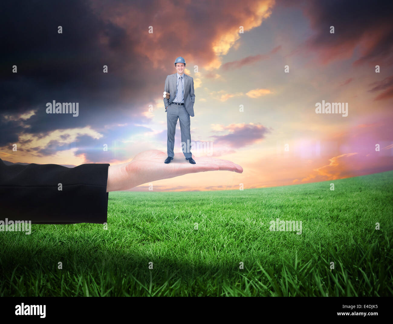 Composite image of smiling attractive architect on phone holding plans Stock Photo
