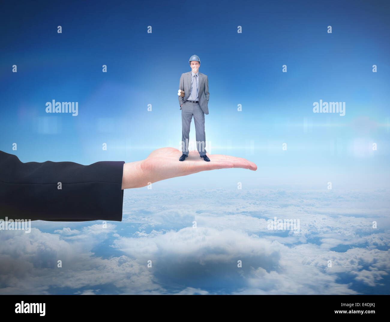 Composite image of smiling attractive architect on phone holding plans Stock Photo