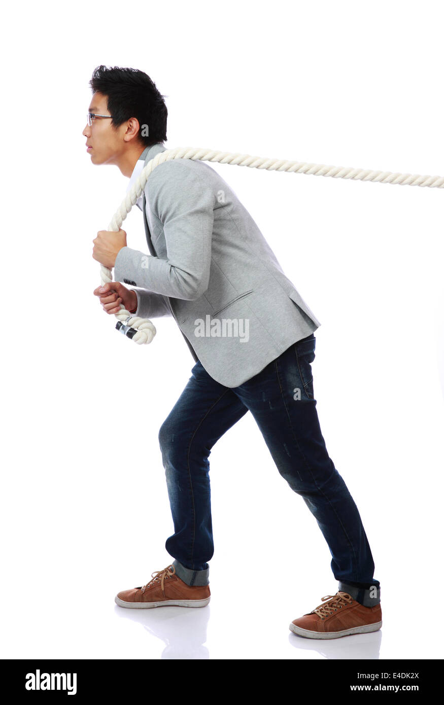 Full length portrait of a man pulling rope over white background