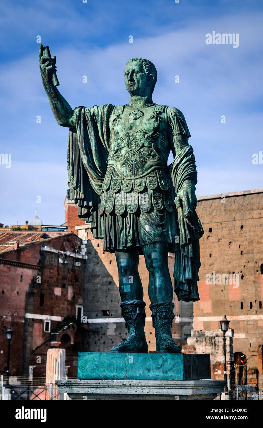 Rome, Italy. Ancient statue of Julius Caesar (Ancient Rome dictator, death in 44BC) in front the remains Forum of Caesar. Stock Photo