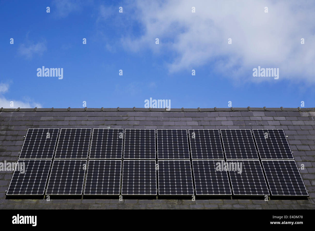 Rooftop solar panels under a blue sky. Stock Photo
