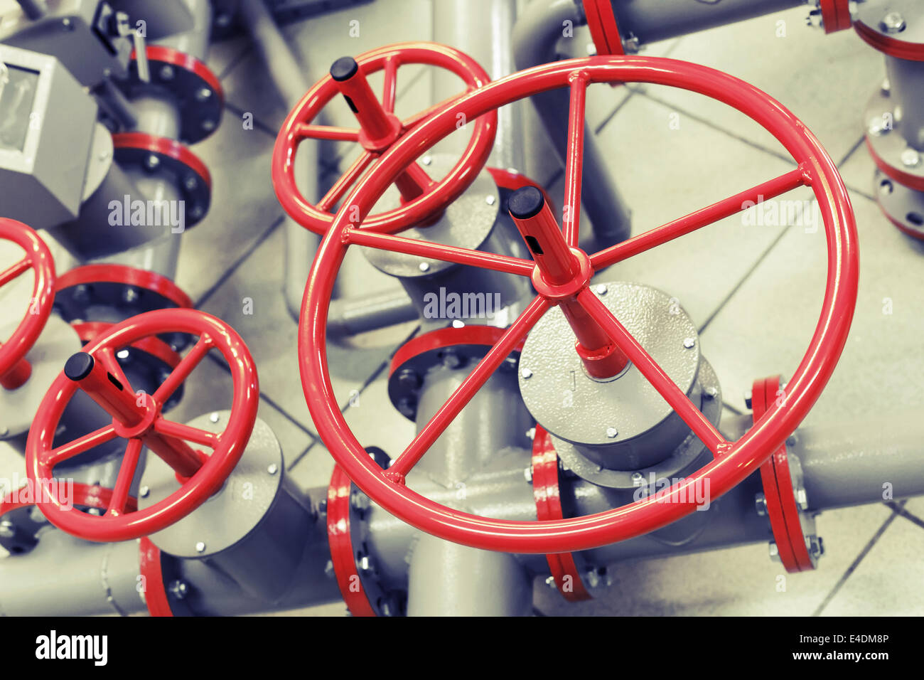 Red industrial valves on modern pipeline system Stock Photo