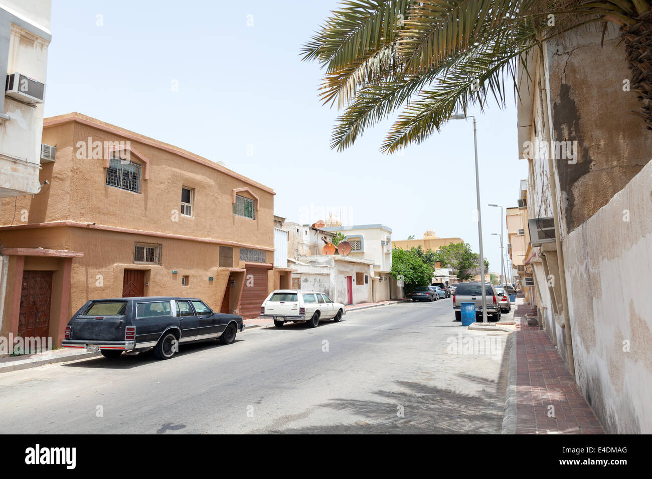 RAS TANURA, SAUDI ARABIA - MAY 10, 2014: Street view with parked cars, Saudi Arabia Stock Photo