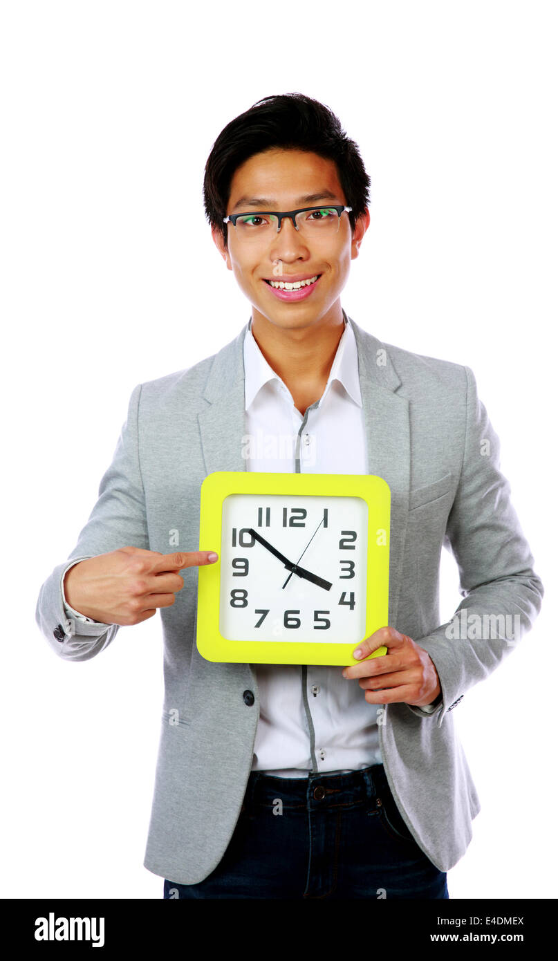 Business time. Business man holding and pointing to a big clock. Stock Photo