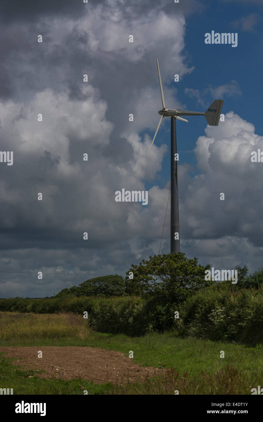 Wind turbine / wind generator set against cloudy summer skies. A 'renewable' form of power useful in the climate change energy mix. Stock Photo