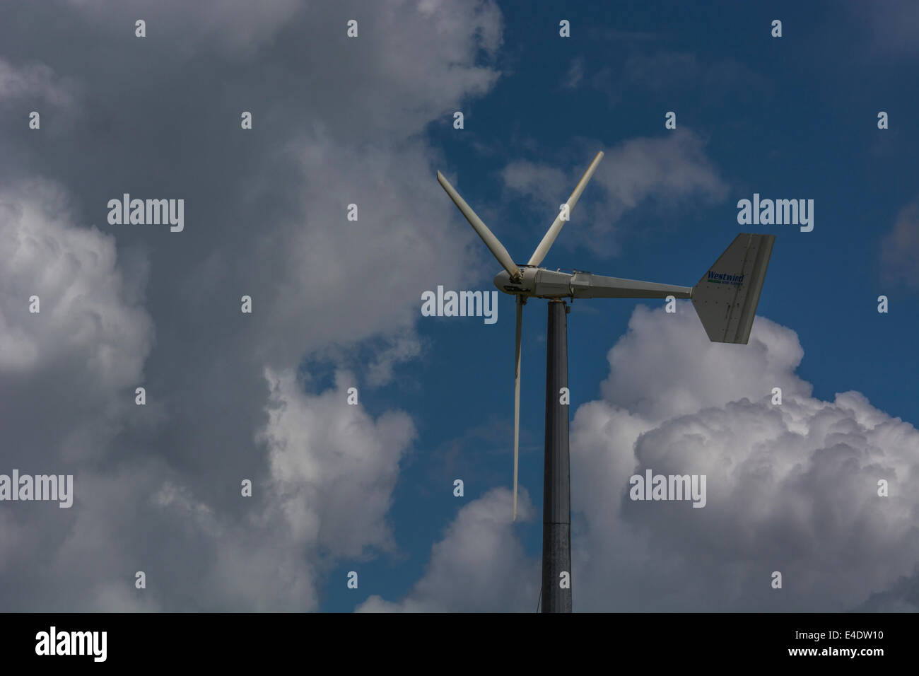 Wind turbine / wind generator set against cloudy summer skies. A 'renewable' form of power useful in the climate change energy mix. Stock Photo