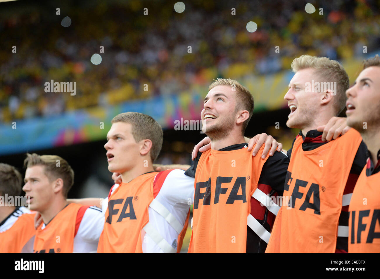 Belo Horizonte, Brazil. 08th July, 2014. German substitute players Erik Durm (L-R), Matthias Ginter, Christoph Kramer and Andre Schuerrle sing during the national anthem during the FIFA World Cup 2014 semi-final soccer match between Brazil and Germany at Estadio Mineirao in Belo Horizonte, Brazil, 08 July 2014. Photo: Thomas Eisenhuth/dpa/Alamy Live News Stock Photo