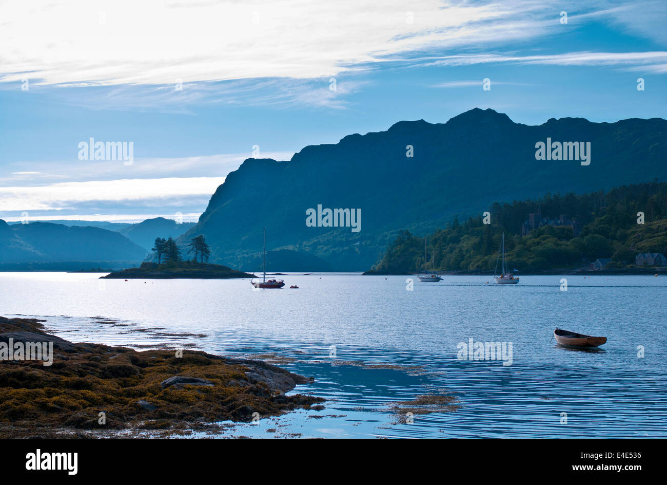 Boats anchored in Plockton harbour, early morning, blue haze, Loch Carron, Wester Ross, Scottish Highlands, Scotland UK Stock Photo