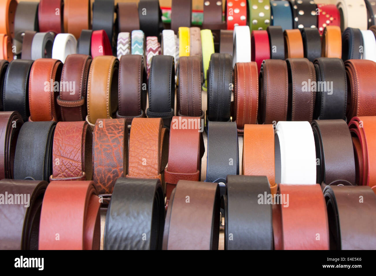 Set of different and colorful leather belts as a background Stock Photo