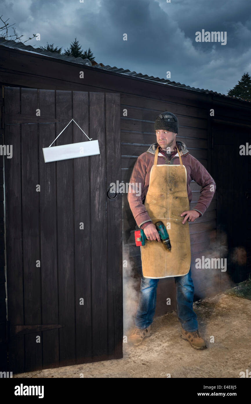 Man wondering what went wrong in his workshop. Stock Photo