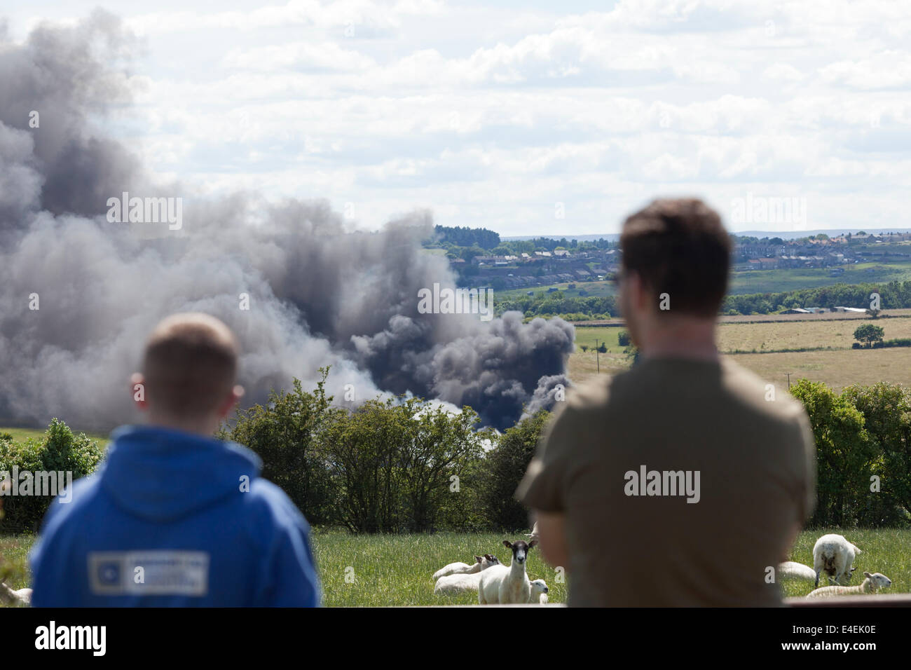 Little Gordon Farm, Lands Bank, Near Cockfield County Durham, UK. 9th July, 2014.  Police are dealing with a large fire at Little Gordon Farm close to the B6282 in which a large number of tyres are ablaze.  Police have closed the road and people living nearby have been told to keep their windows closed. Over 40 fire fighters and police officers are currently at the scene. Credit:  David Forster/Alamy Live News Stock Photo