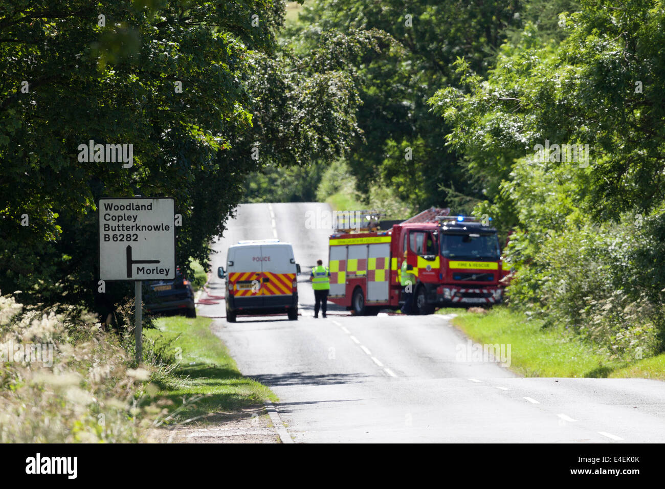 Little Gordon Farm, Lands Bank, Near Cockfield County Durham, UK. 9th July, 2014.  Police are dealing with a large fire at Little Gordon Farm close to the B6282 in which a large number of tyres are ablaze.  Police have closed the road and people living nearby have been told to keep their windows closed. Over 40 fire fighters and police officers are currently at the scene. Credit:  David Forster/Alamy Live News Stock Photo