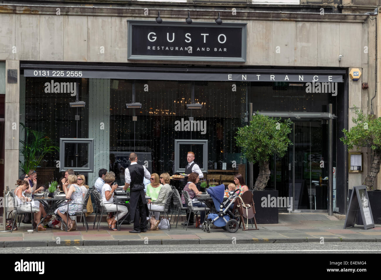 Shoppers and tourists enjoying a meal outside of the Gusto Restaurant and Bar on George Street Edinburgh Stock Photo