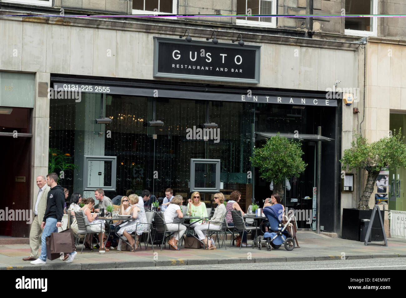 Shoppers and tourists enjoying a meal outside of the Gusto Restaurant and Bar on George Street Edinburgh Stock Photo