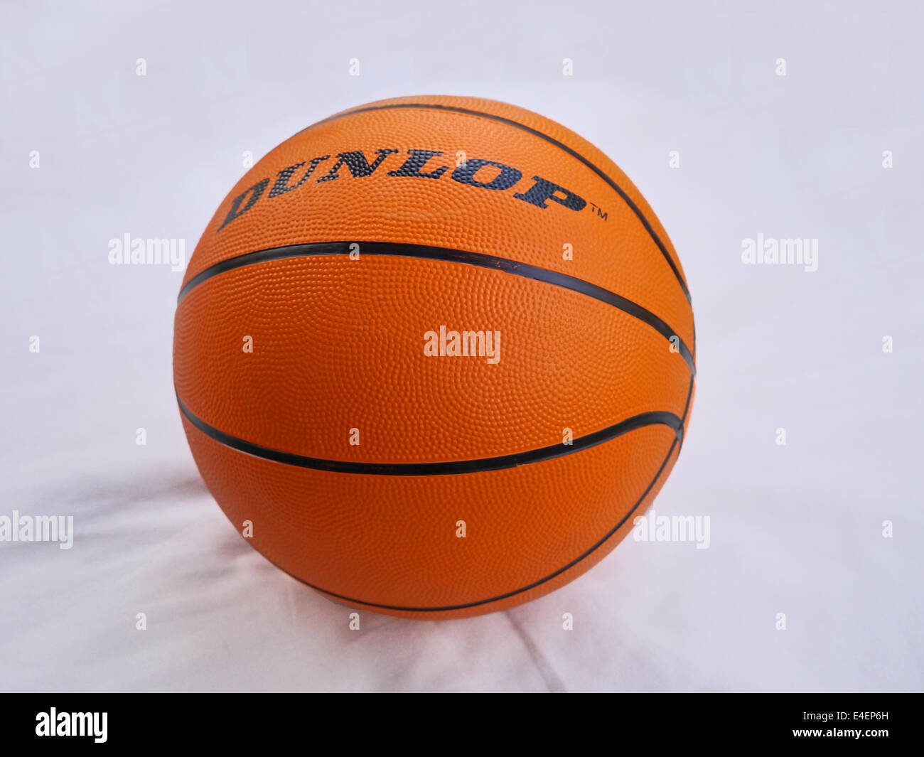 An orange basketball on a plain white background Stock Photo