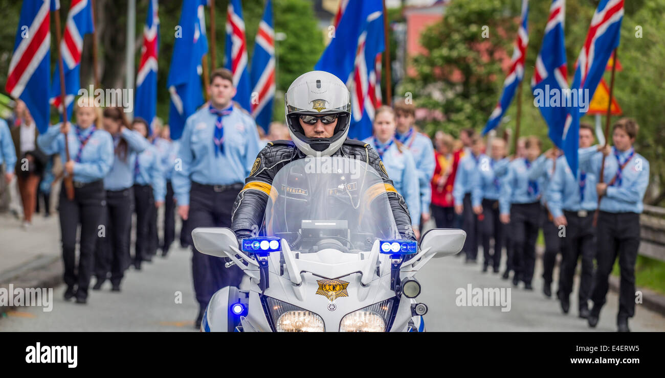 Scouts are being lead by a motorcade during a parade, celebrating Independence day, Reykjavik, Iceland Stock Photo