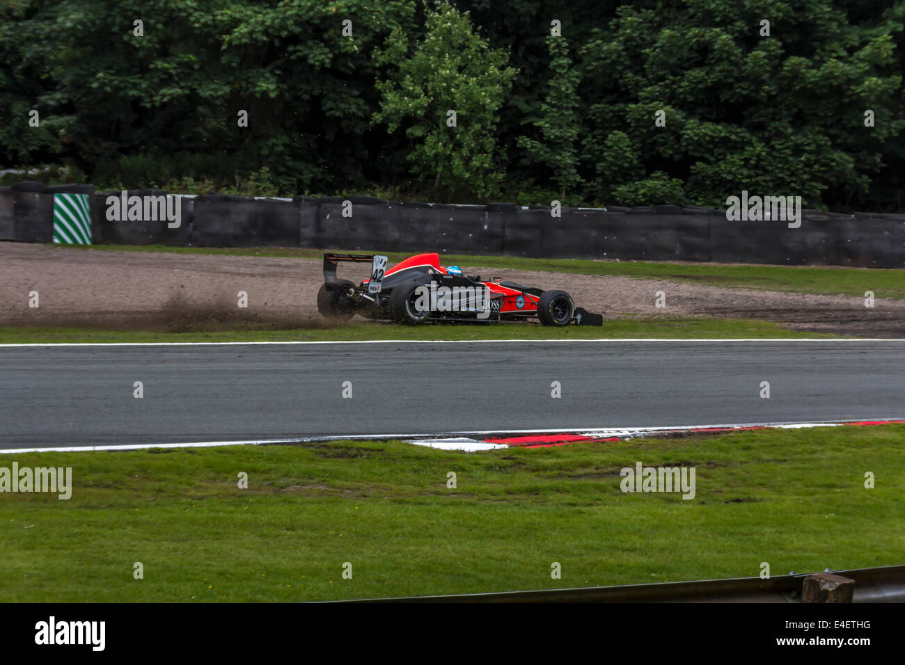 Racing car leaving the race track on a bend at Oulton Park Stock Photo