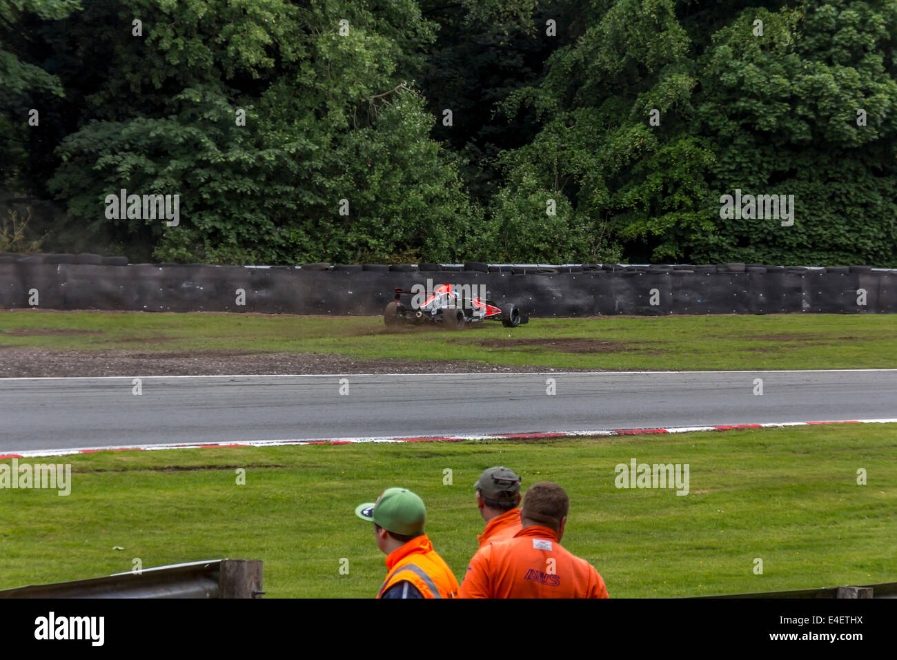 Racing car leaving the race track on a bend at Oulton Park Stock Photo