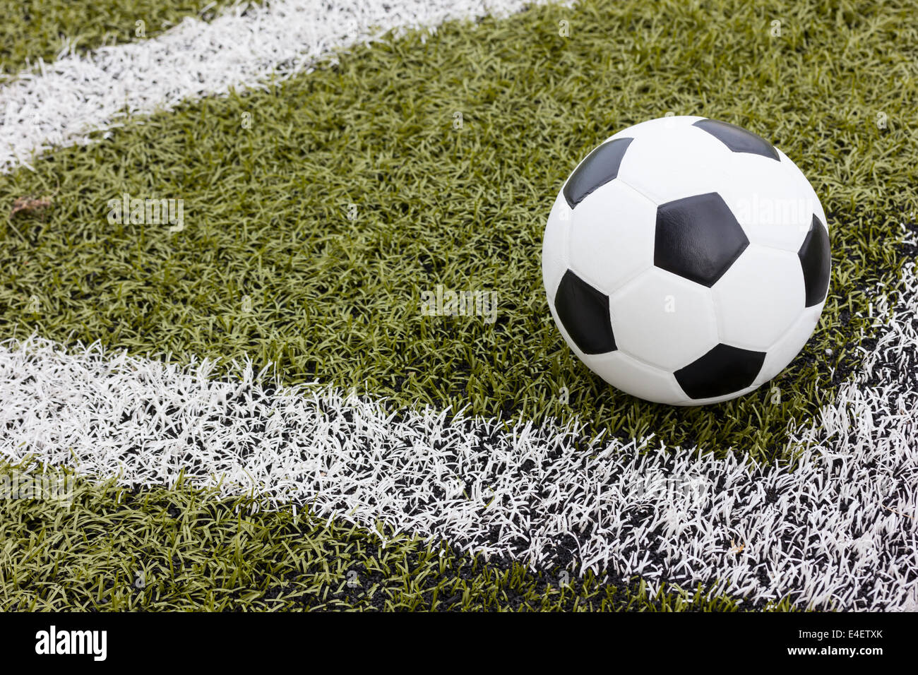 Soccer ball on green field Stock Photo