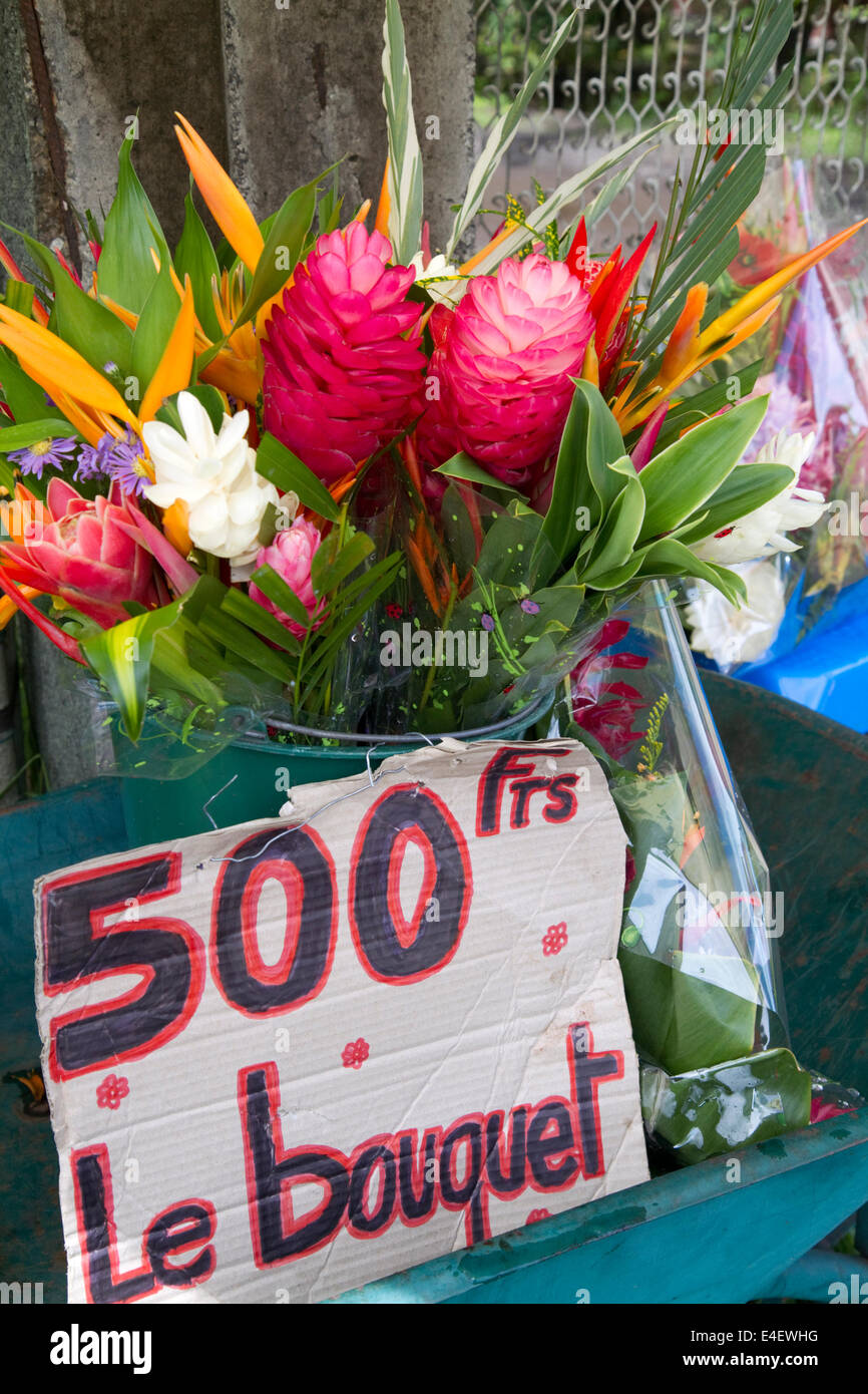A bouquet of tropical flowers being sold at a self serve stand on Tahiti, French Polynesia. Stock Photo