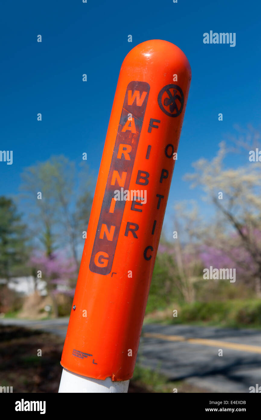 Closeup of a warning post for underground fiber optic cables in Virginia, USA. Stock Photo