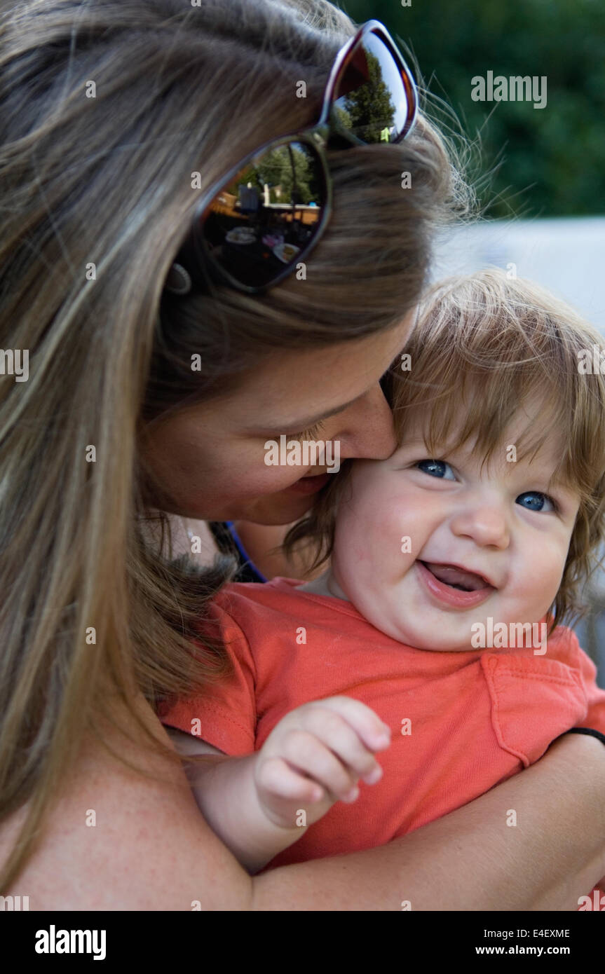 Young Mother Hugging her Baby Son Stock Photo
