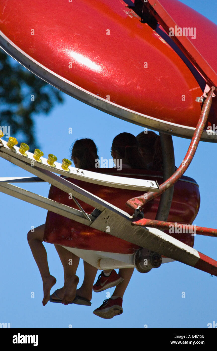 Three Girls on Amusement Ride at the Fairgrounds in New Pekin Indiana during their Independence Day Celebration Stock Photo