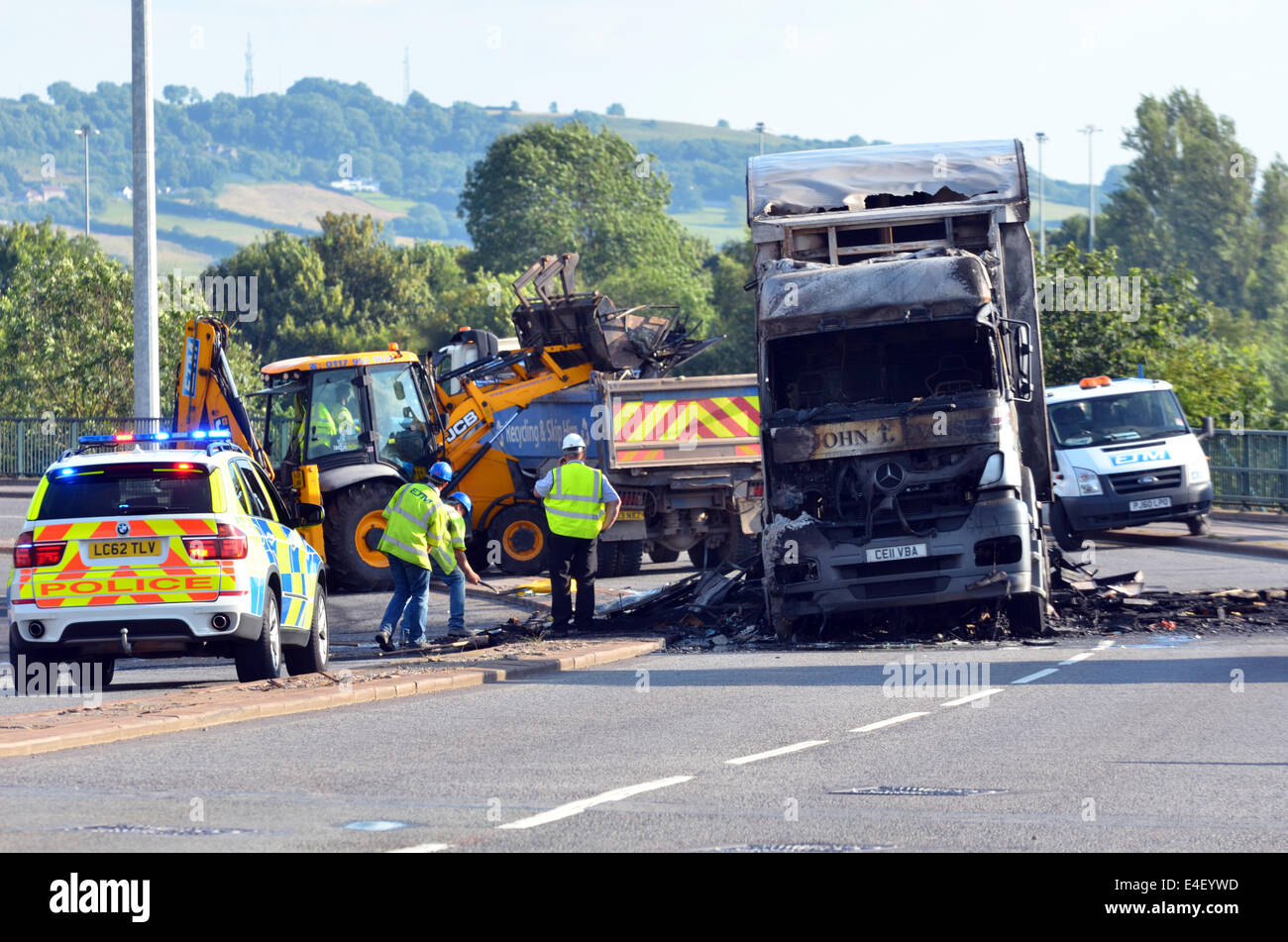 Bristol, UK. 9th July, 2014. Police and Workmen start a cleanup operation at Cumberland Basin Flyover where a major incident of a lorry fire occurred earlier in the day. Credit:  Robert Timoney/Alamy Live News Stock Photo