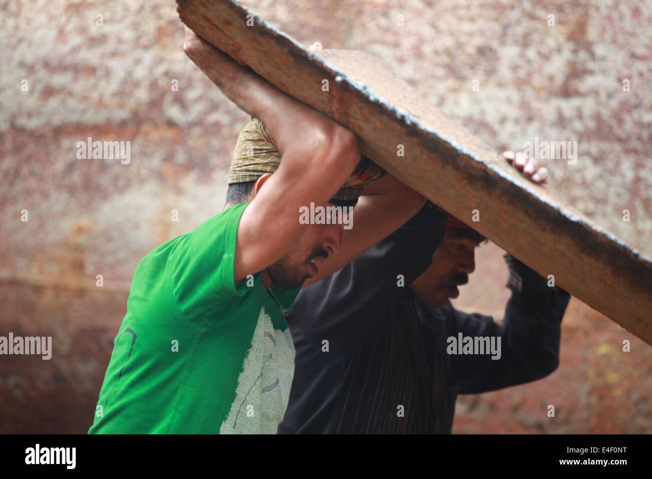 ship building yard,Adult,Asian Ethnicity,Bangladesh,Boat,Boatyard,Carrying On Head,Color Image,Construction,Dacca,Day,Developing Stock Photo