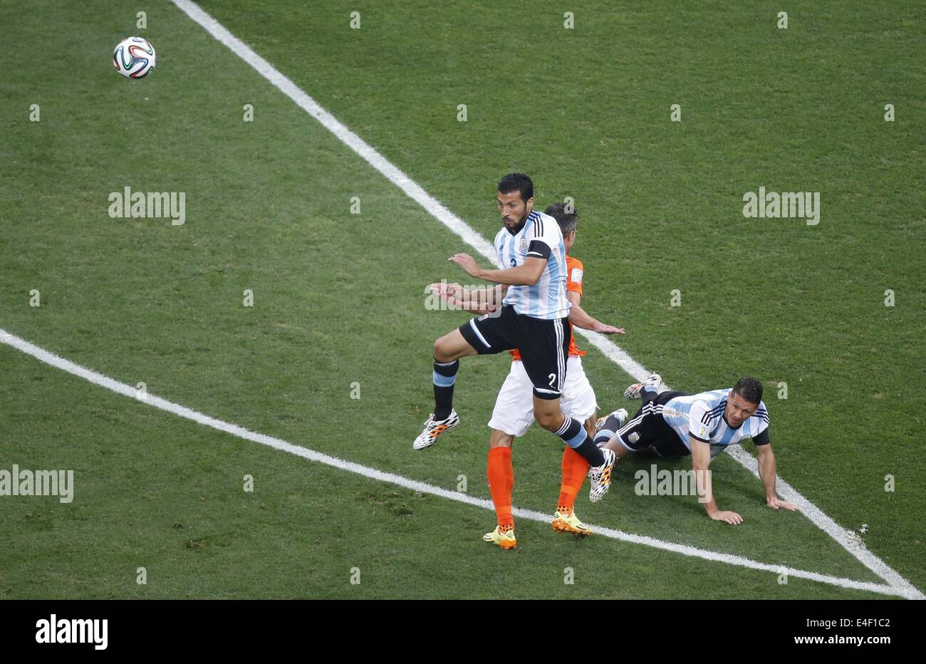 Sao Paulo, Brazil. 9th July, 2014. Argentina's Ezequiel Garay (L) jumps for a header during a semifinal match between Netherlands and Argentina of 2014 FIFA World Cup at the Arena de Sao Paulo Stadium in Sao Paulo, Brazil, on July 9, 2014. Credit:  Liao Yujie/Xinhua/Alamy Live News Stock Photo