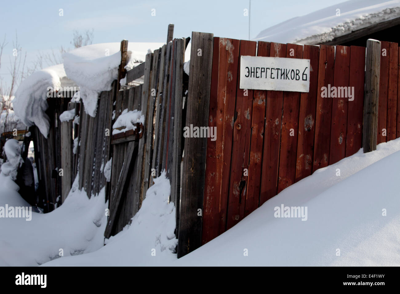 Wooden fence snow covered Russian sign drift Stock Photo