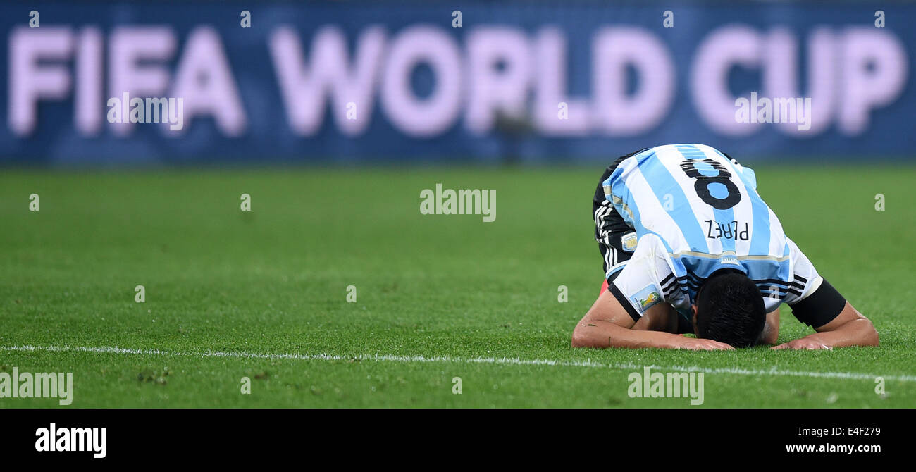 Sao Paulo, Brazil. 09th July, 2014. Enzo Perez of Argentina knees on the pitch during the FIFA World Cup 2014 semi-final soccer match between the Netherlands and Argentina at the Arena Corinthians in Sao Paulo, Brazil, 09 July 2014. Photo: Marius Becker/dpa/Alamy Live News Stock Photo