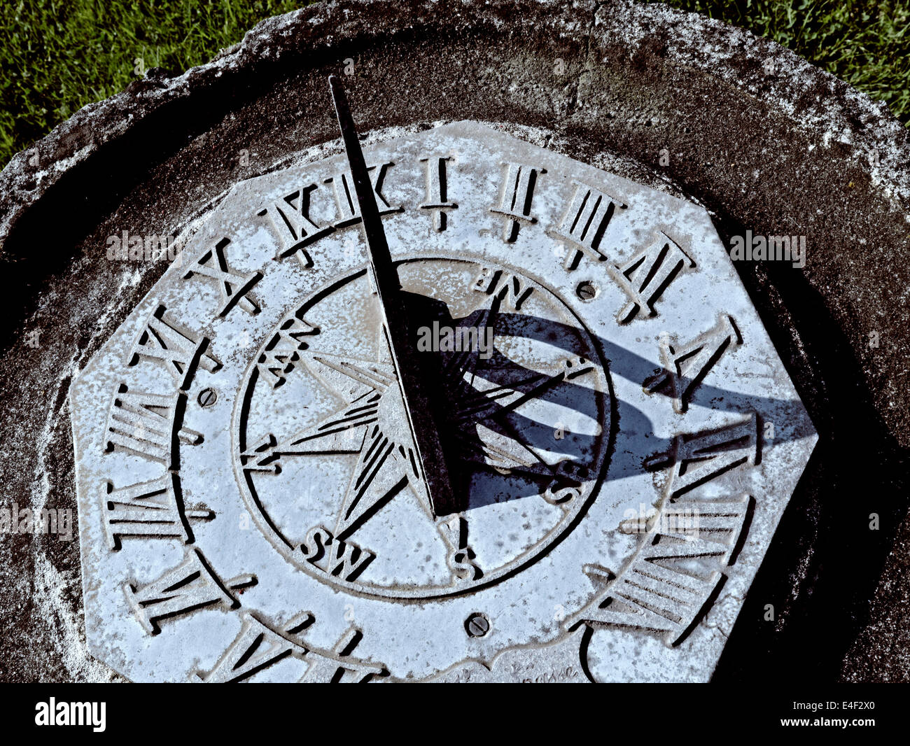 Garden sundial close up showing a GMT summertime six o'clock Stock Photo