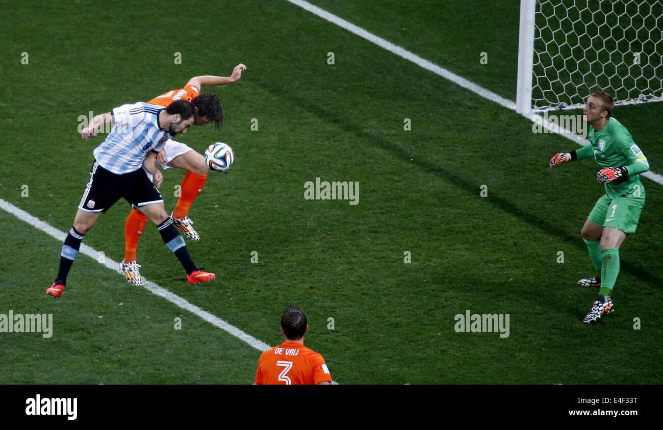 Sao Paulo, Brazil. 9th July, 2014. Argentina's Gonzalo Higuain (1st L) vies for a header with Netherlands' Daryl Janmaat as Netherlands' goalkeeper Jasper Cillessen (1st R) denfends during a semifinal match between Netherlands and Argentina of 2014 FIFA World Cup at the Arena de Sao Paulo Stadium in Sao Paulo, Brazil, on July 9, 2014. Credit:  Liao Yujie/Xinhua/Alamy Live News Stock Photo