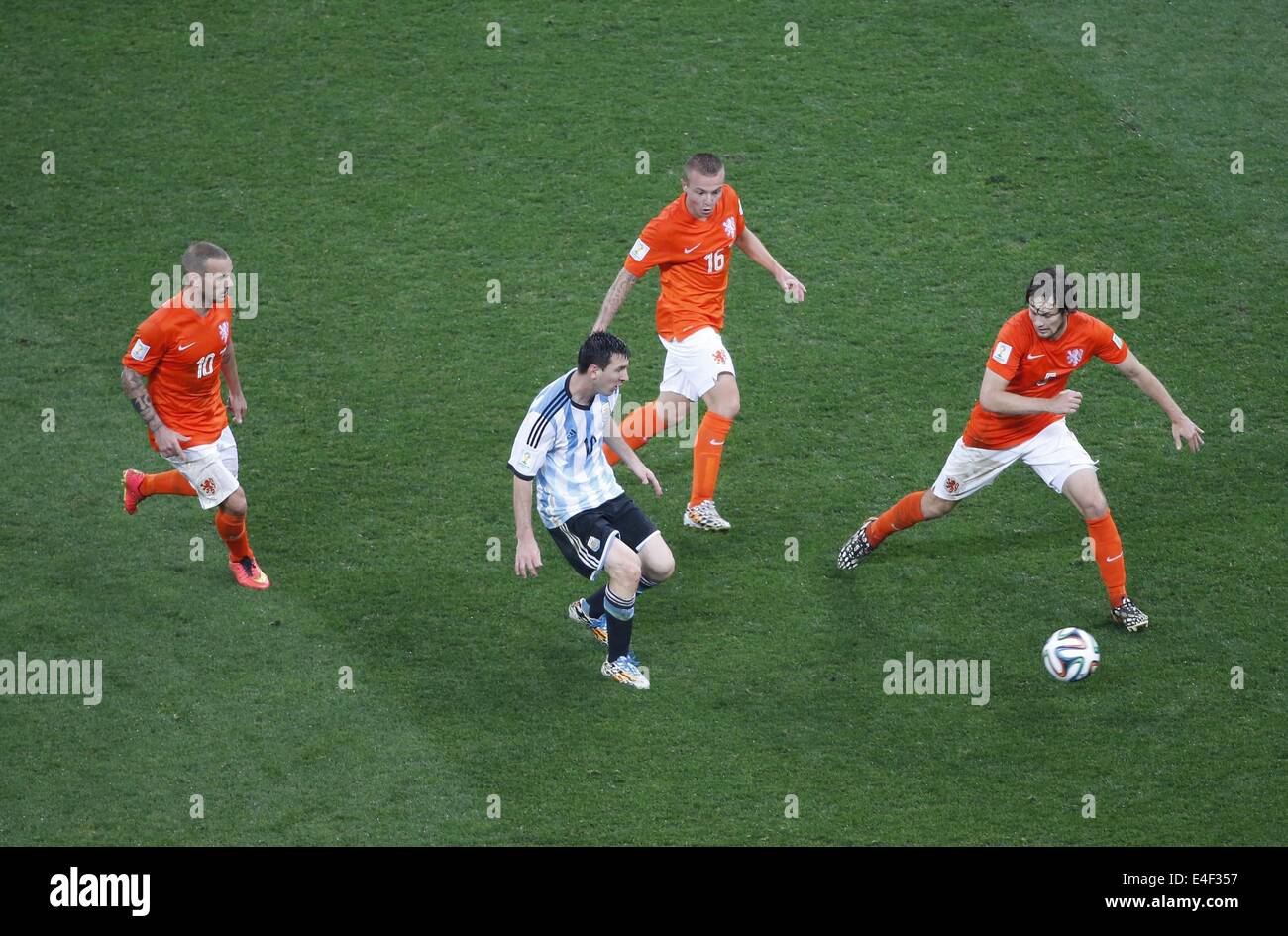 Sao Paulo, Brazil. 9th July, 2014. Netherlands' Wesley Sneijder (1st L), Jordy Clasie (2nd R) and Daley Blind (1st R) vie with Argentina's Lionel Messi (2nd L) during a semifinal match between Netherlands and Argentina of 2014 FIFA World Cup at the Arena de Sao Paulo Stadium in Sao Paulo, Brazil, on July 9, 2014. Credit:  Liao Yujie/Xinhua/Alamy Live News Stock Photo