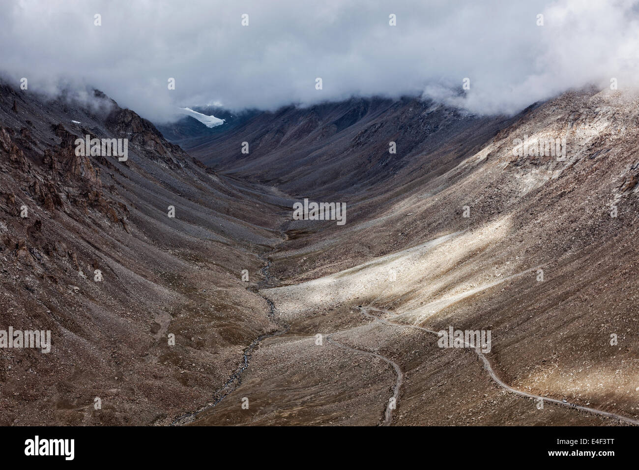 Himalayan valley landscape with road near Kunzum La pass - allegedly the highest motorable pass in the world (5602 m), Ladakh Stock Photo