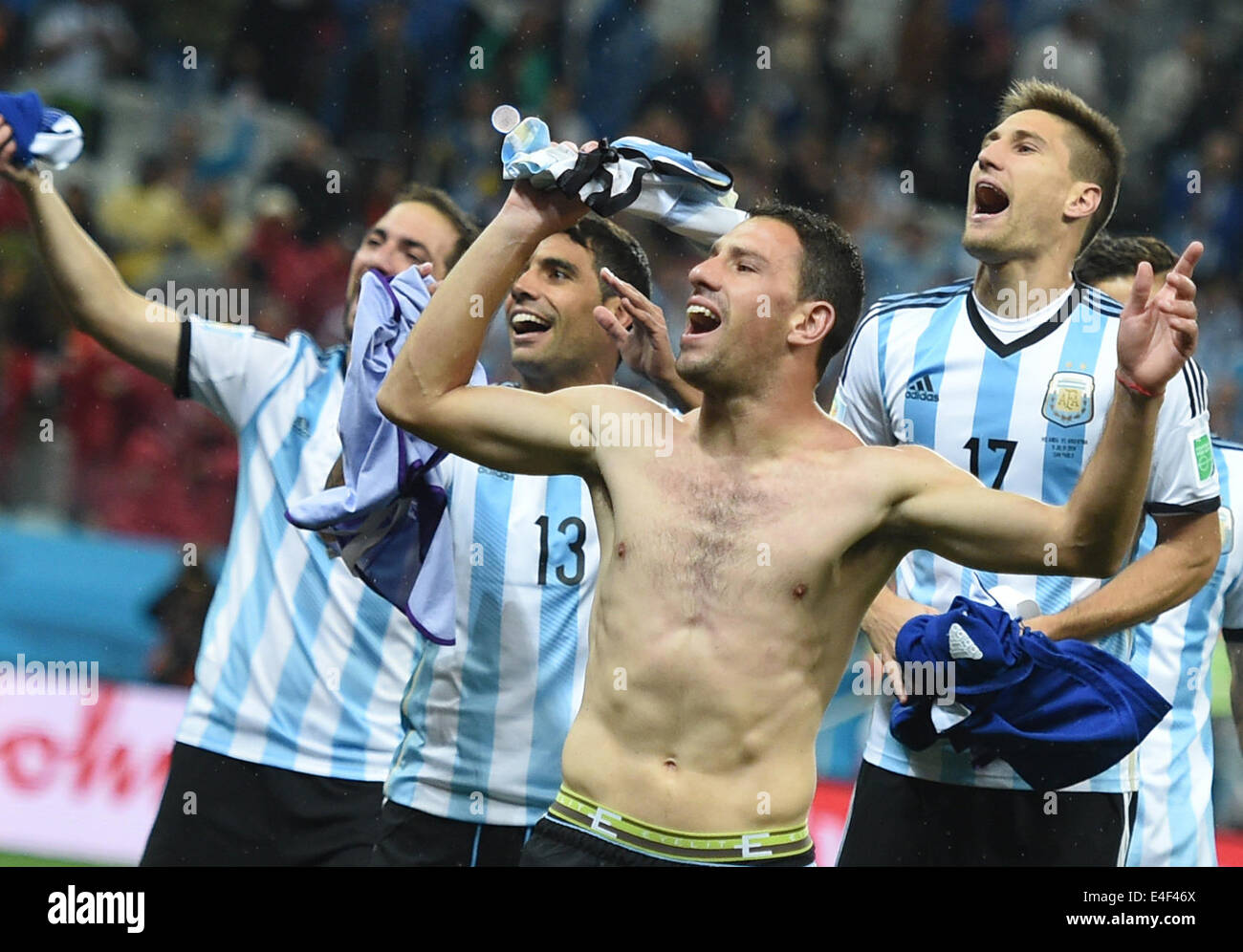 Sao Paulo, Brazil. 09th July, 2014. Argentina's Maxi Rodriguez (C) celebrates after the FIFA World Cup 2014 semi-final soccer match between the Netherlands and Argentina at the Arena Corinthians in Sao Paulo, Brazil, 09 July 2014. Photo: Marius Becker/dpa/Alamy Live News Stock Photo
